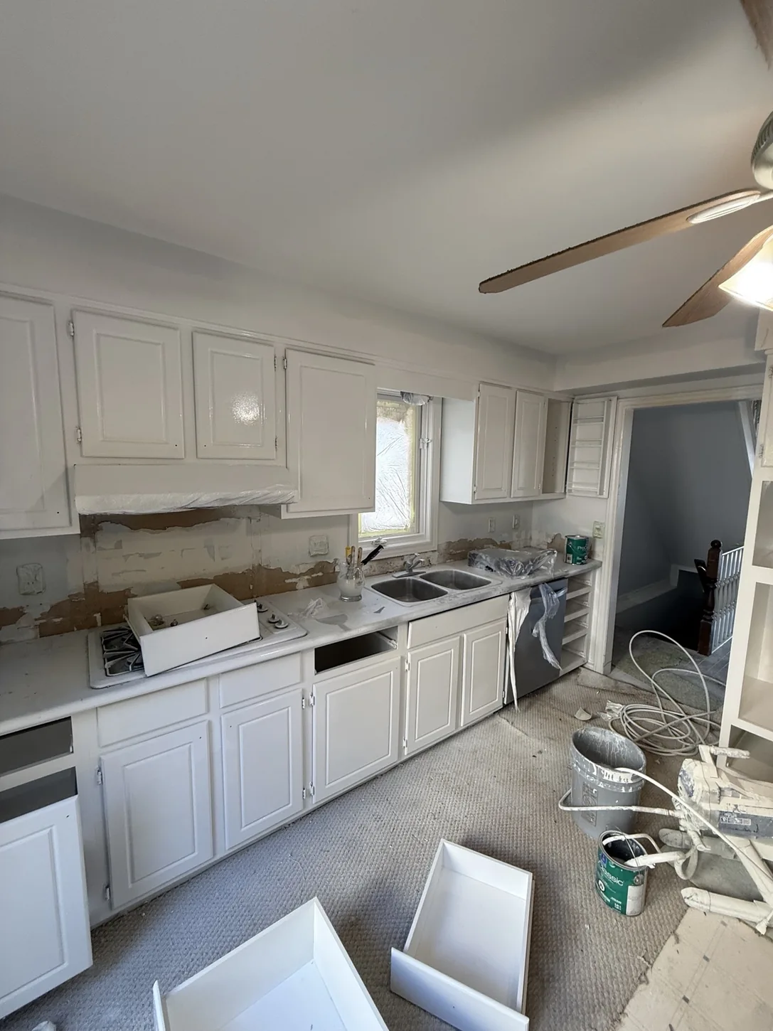 White kitchen cabinetry during refinishing work
